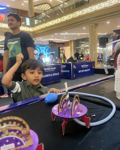 A boy punching the air after launching his rocket in the space zone