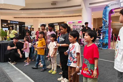 Children queueing along a mall concourse for a MakerMasti activity