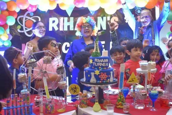 A Space Explorers birthday setup with a balloon arch, planets and a decorated table