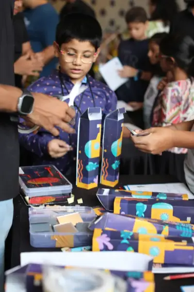 Children examining colourful spy dossiers and props at a Be a Detective birthday party