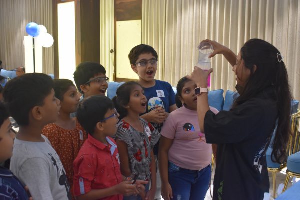 Showing science activity to kids in themed birthday party