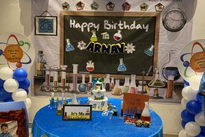 science themed birthday cake on table decorated with science theme