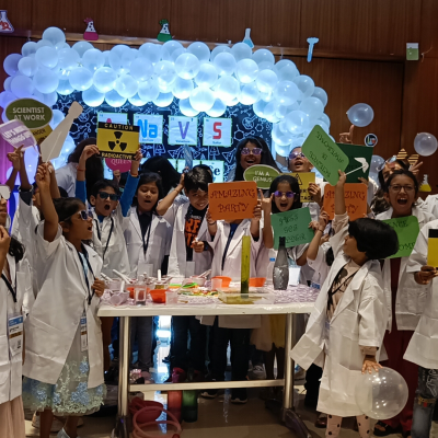 Kids in lab coat having fun in science themed birthday party