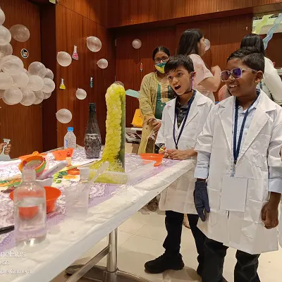 children performing funny science experiments wearing white apron