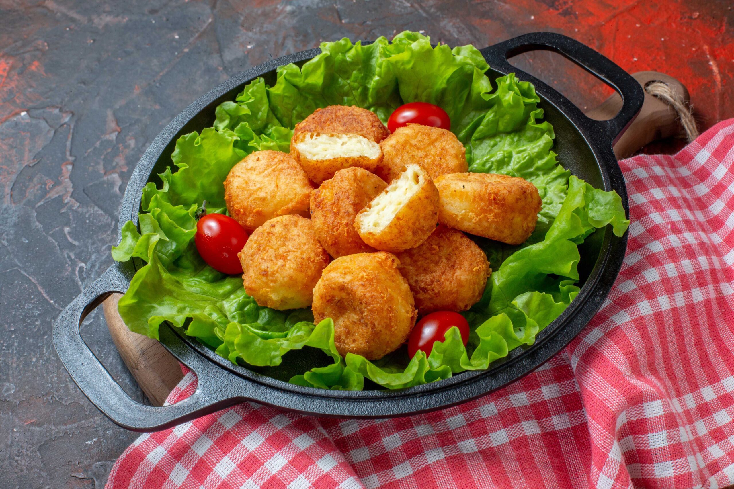 bottom-view-chicken-nuggets-lettuce-cherry-tomatoes-pan-dark-red-background (1)