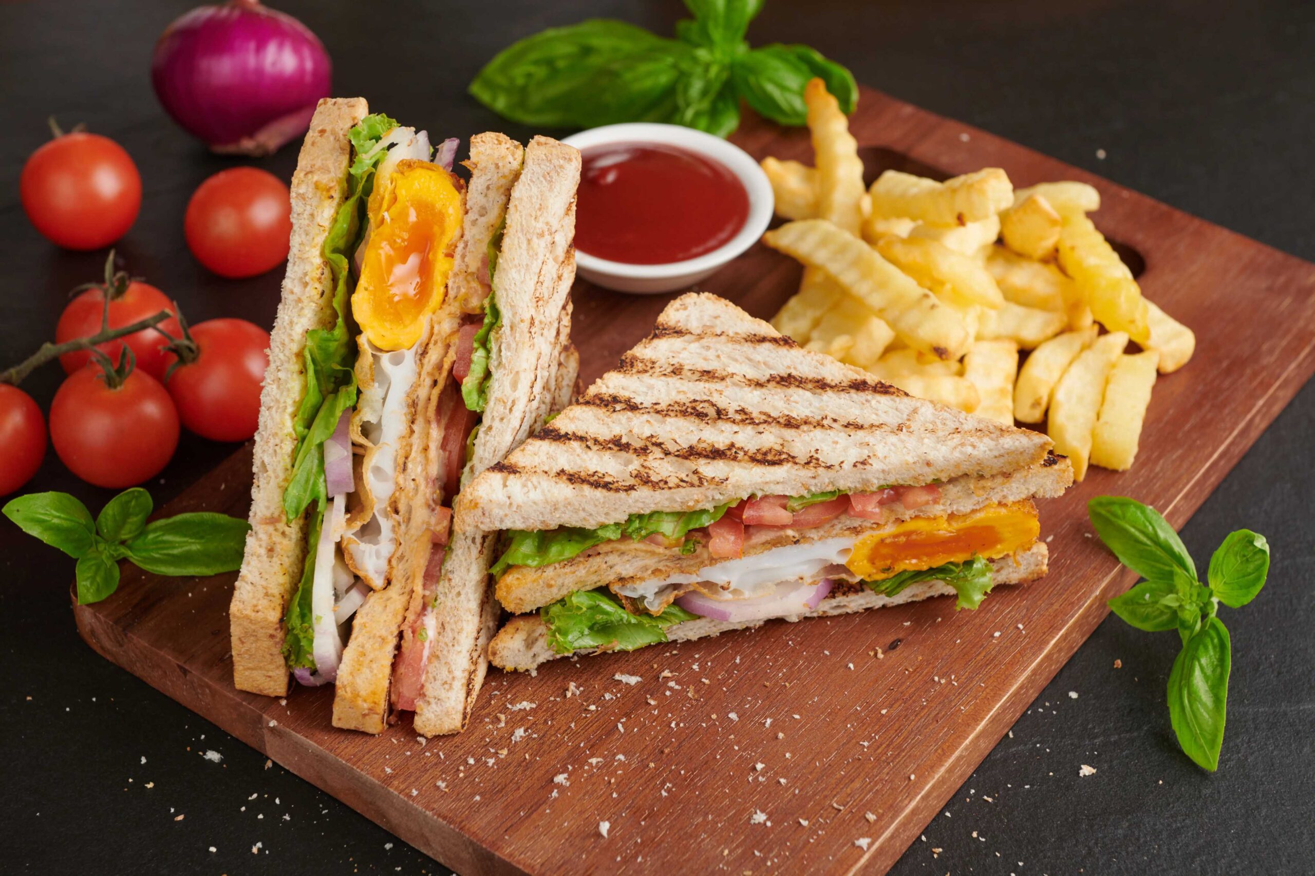 grilled-sandwich-with-bacon-fried-egg-tomato-lettuce-served-wooden-cutting-board (1)
