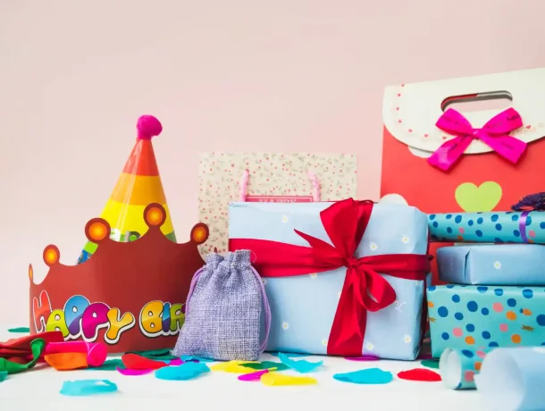 present-boxes-with-crowns-balloons-shopping-bags-against-pink-background (2) (1)